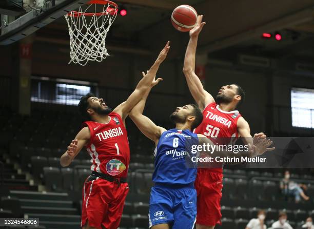 Patrick Samoura of Czech Republic is challenged by Oussama Marnaoui and Salah Mejri of Tunisia during the Basketball Supercup 2021 between Tunisia...