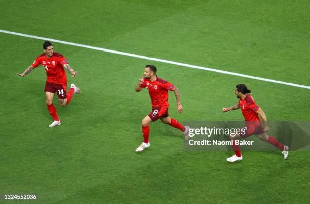 Haris Seferovic of Switzerland celebrates with teammates Steven Zuber and Ricardo Rodriguez after scoring their team's first goal during the UEFA...