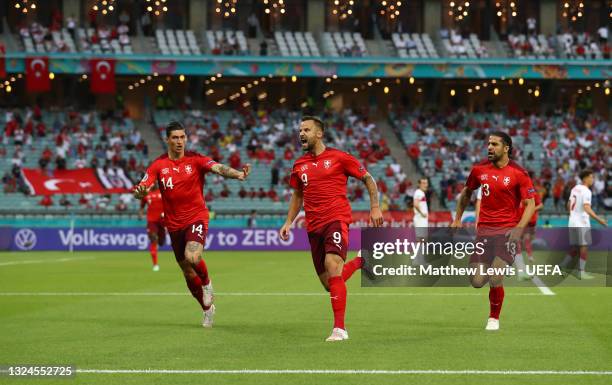 Haris Seferovic of Switzerland celebrates with teammates Steven Zuber and Ricardo Rodriguez after scoring their team's first goal during the UEFA...