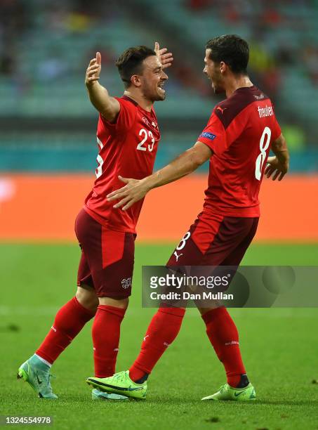 Xherdan Shaqiri of Switzerland celebrates with team mate Remo Freuler after scoring their team's second goal during the UEFA Euro 2020 Championship...