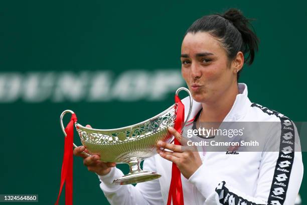 Ons Jabeur of Tunisia celebrates with the Maud Watson Trophy after victory against Daria Kasatkina of Russia in the Womens Singles Final of the...