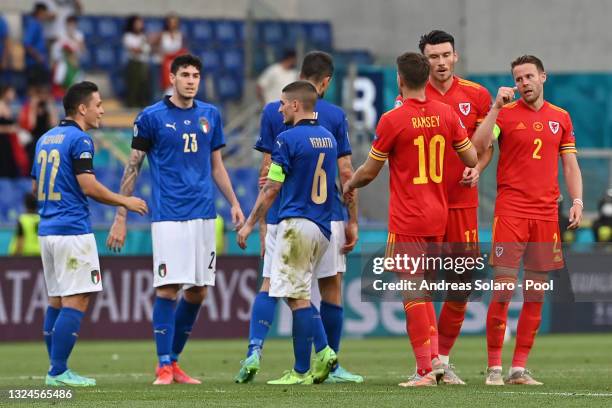 Kieffer Moore of Wales interacts with team mates Aaron Ramsey and Chris Gunter as Giacomo Raspadori, Alessandro Bastoni and Marco Verratti of Italy...