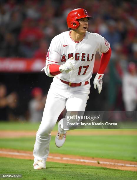 Shohei Ohtani of the Los Angeles Angels watches the ball clear the wall on a two run home run in the fifth inning of the game against the Detroit...