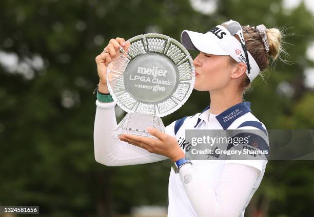 Nelly Korda kisses the trophy after winning the Meijer LPGA Classic for Simply Give at Blythefield Country Club on June 20, 2021 in Grand Rapids,...