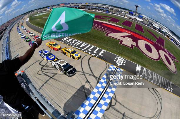 Aric Almirola, driver of the Smithfield Ford, and Kyle Busch, driver of the Pedigree Toyota, lead the field to the green flag to start the NASCAR Cup...