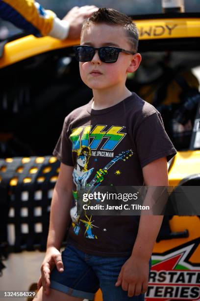 Kyle Busch, driver of the Pedigree Toyota, , son Brexton stands on the grid prior to the NASCAR Cup Series Ally 400 at Nashville Superspeedway on...