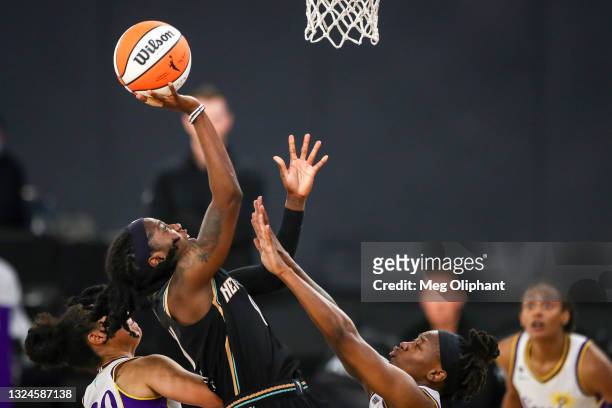 Guard Jazmine Jones of the New York Liberty shoots defended by guard Erica Wheeler of the Los Angeles Sparks at Los Angeles Convention Center on June...
