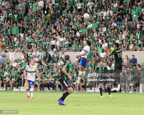 Cade Cowell of San Jose Earthquakes heads the ball while gaurded by Matt Besler and Julio Cascante of Austin FC during the inaugural game at Q2...
