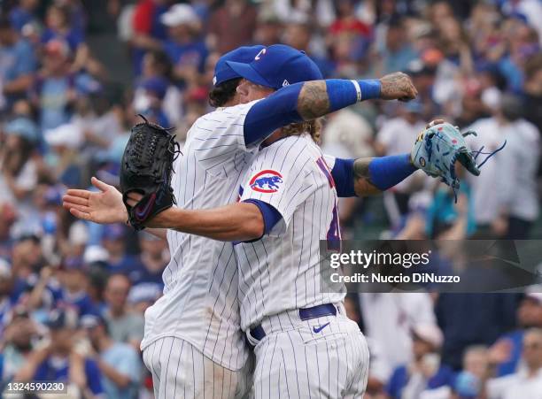 Craig Kimbrel of the Chicago Cubs gets a hug from Javier Baez after their win over the Miami Marlins at Wrigley Field on June 20, 2021 in Chicago,...