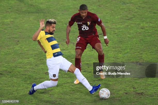 Christian Noboa of Ecuador competes for the ball with Edson Castillo of Venezuela during a Group B match between Venezuela and Ecuador as part of...