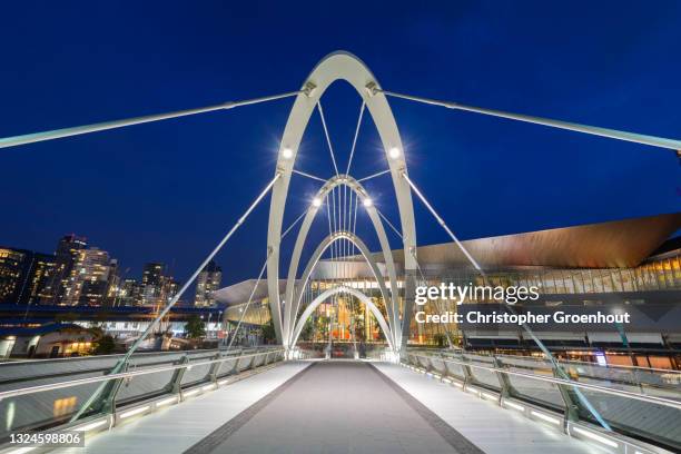 the seafarers footbridge crosses the yarra river in melbourne - groenhout melbourne stock pictures, royalty-free photos & images