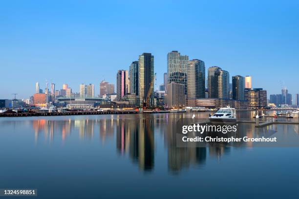 victoria harbor in the docklands district of melbourne at dusk - groenhout melbourne stock pictures, royalty-free photos & images