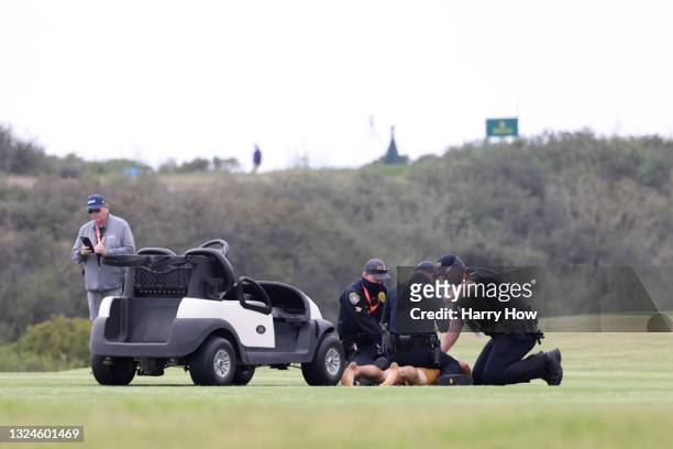 Streaker is detained on the 13th hole during the final round of the 2021 U.S. Open at Torrey Pines Golf Course on June 20, 2021 in San Diego,...