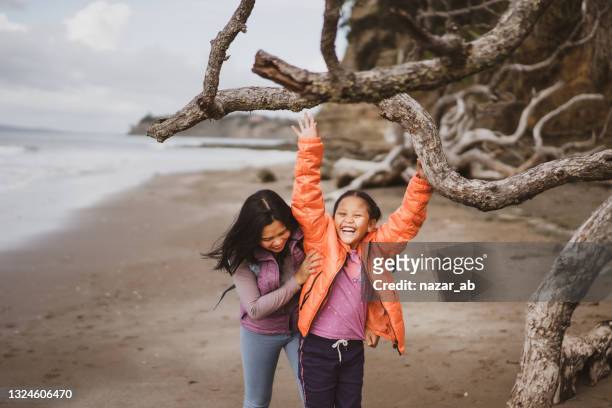 mother and daughter playing together on hiking. - new zealand stock pictures, royalty-free photos & images
