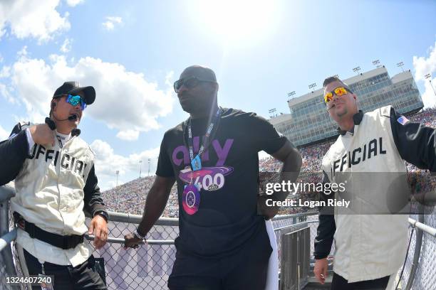 Former NFL player Bernard Pollard and NASCAR officials talk in the flag-stand during the NASCAR Cup Series Ally 400 at Nashville Superspeedway on...