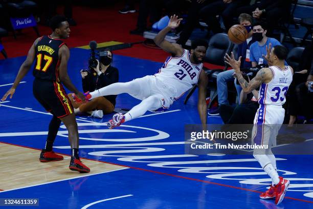 Joel Embiid of the Philadelphia 76ers passes to George Hill during the first quarter against the Atlanta Hawks during Game Seven of the Eastern...