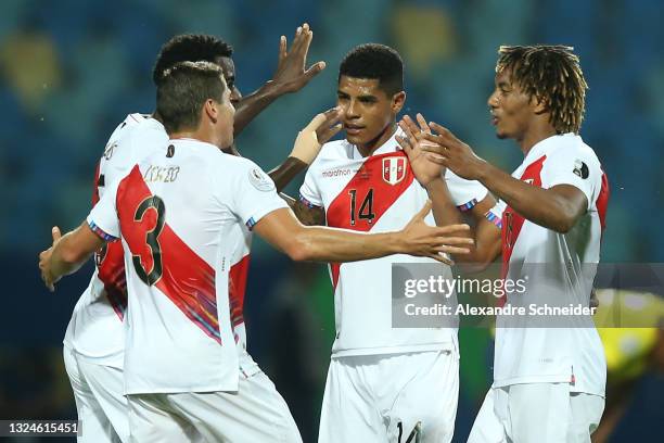 Aldo Corzo of Peru celebrates with teammates Christian Ramos, Wilder Cartagena and André Carrillo after winning a group B match between Colombia and...