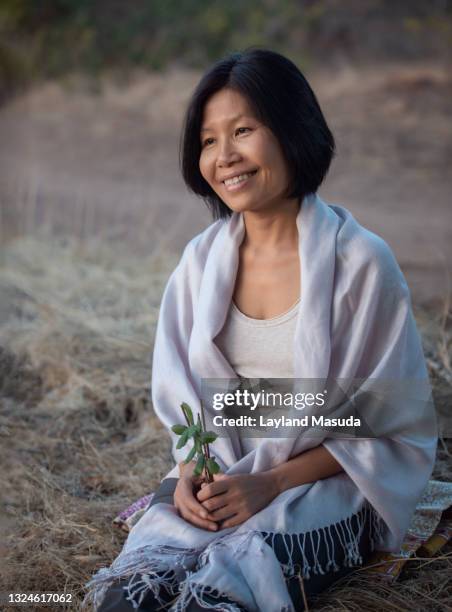 smiling woman holding incense and leaves - shawl stockfoto's en -beelden