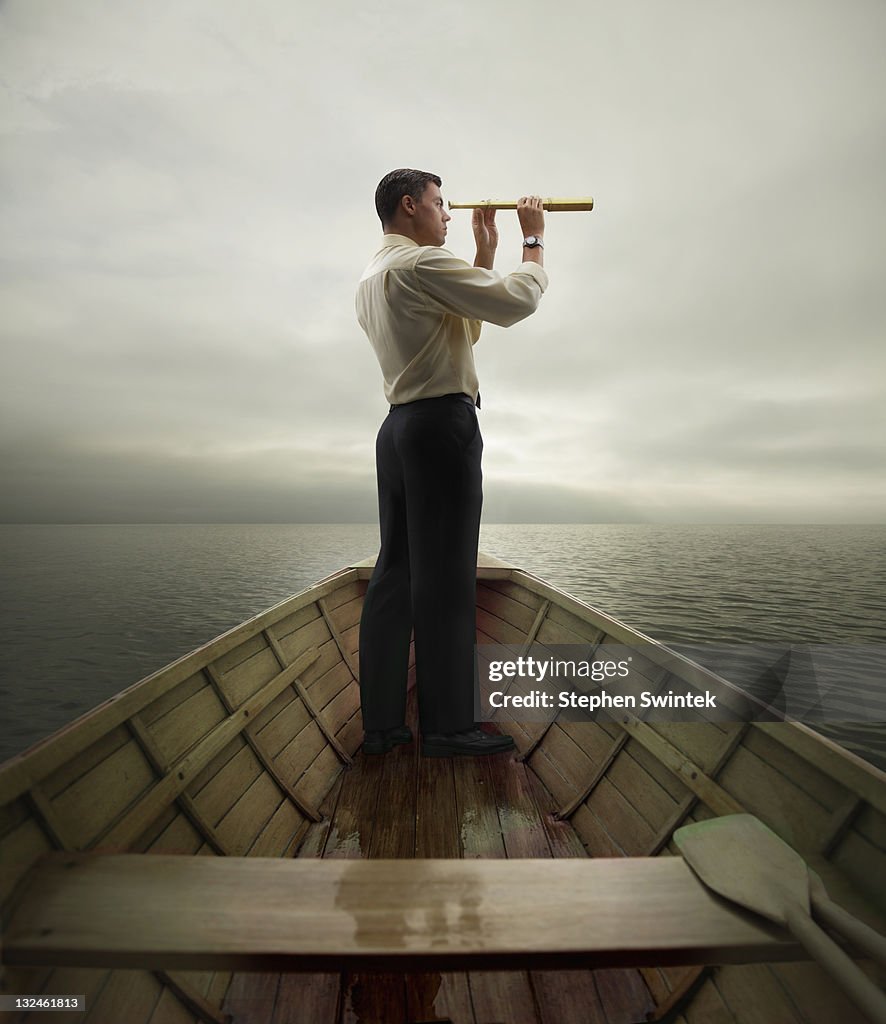 Man in boat looking through spyglass
