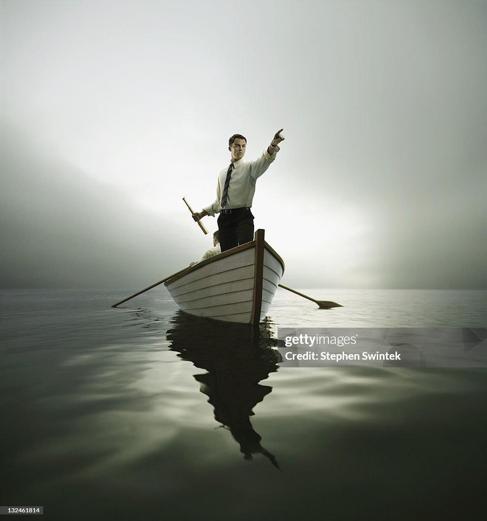 Man in bow of boat pointing