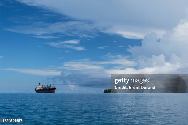 commercial fishing vessel and tropic island - indo pacific ocean stock pictures, royalty-free photos & images