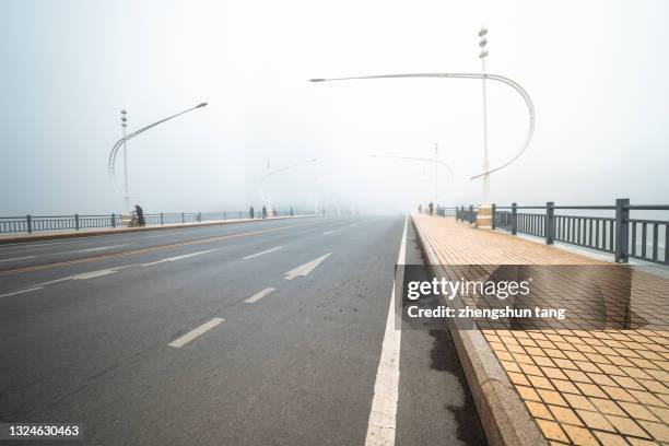 city highway in fog. - eastern avenue stock pictures, royalty-free photos & images