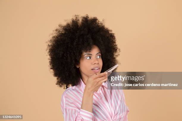 mixed afro woman command an audio with her smartphone - voice search stock pictures, royalty-free photos & images