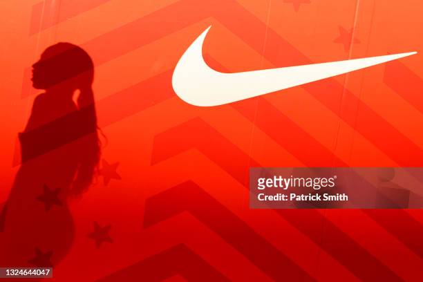 The shadow of Allyson Felix is seen next to a Nike logo after finishing second place in the Women's 400 Meters Final on day three of the 2020 U.S....