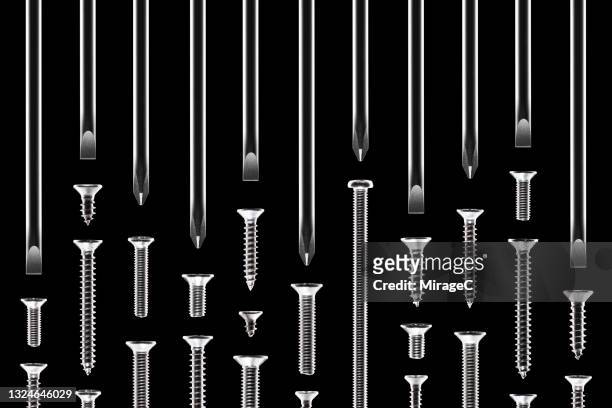 screwdrivers aimed at many different types of screws - schraubenzieher stock-fotos und bilder