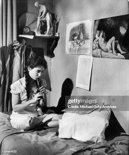 Kathleen Widdoes relaxes and practices playing the recorder in her room in a scene from the film 'The Group', 1966.