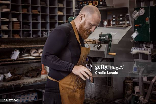 cobbler working in a shoemaker store after reopening in the new normal - cobbler stock pictures, royalty-free photos & images