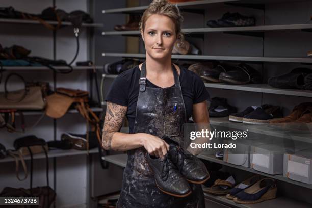 female cobbler working in a shoemaker store after reopening in the new normal - shoe maker stock pictures, royalty-free photos & images