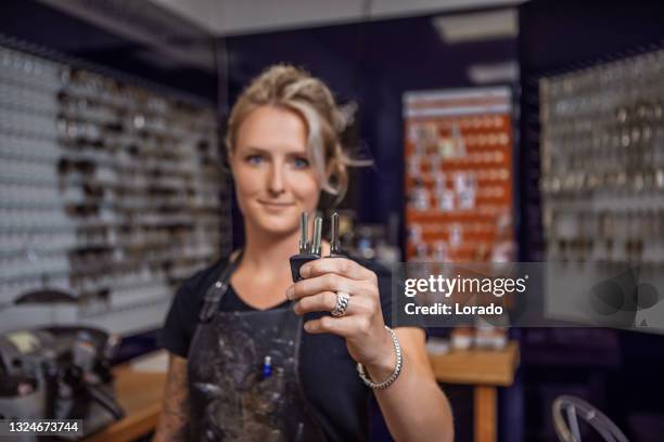 female locksmith working in a store after reopening in the new normal - locksmith stock pictures, royalty-free photos & images