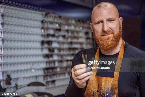 a locksmith working in a store after reopening in the new normal - serralheiro imagens e fotografias de stock