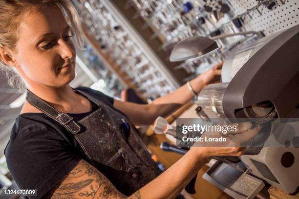 female locksmith working in a store after reopening in the new normal - locksmith stock pictures, royalty-free photos & images