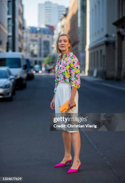 Tina Haase is seen wearing white Bermuda shorts &other stories, Essentiel Antwerp blouse with floral print, orange Fendi bag, pink Zara he on June...