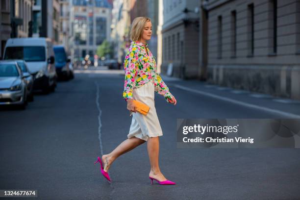 Tina Haase is seen wearing white Bermuda shorts &other stories, Essentiel Antwerp blouse with floral print, orange Fendi bag, pink Zara he on June...