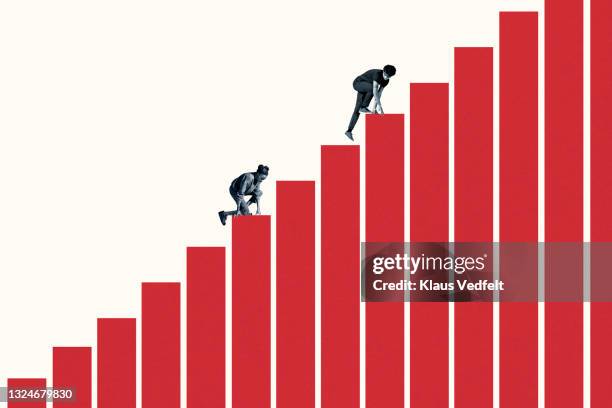 young woman and man climbing red bar graph - progreso conceptos fotografías e imágenes de stock