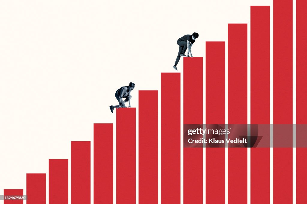 Young woman and man climbing red bar graph