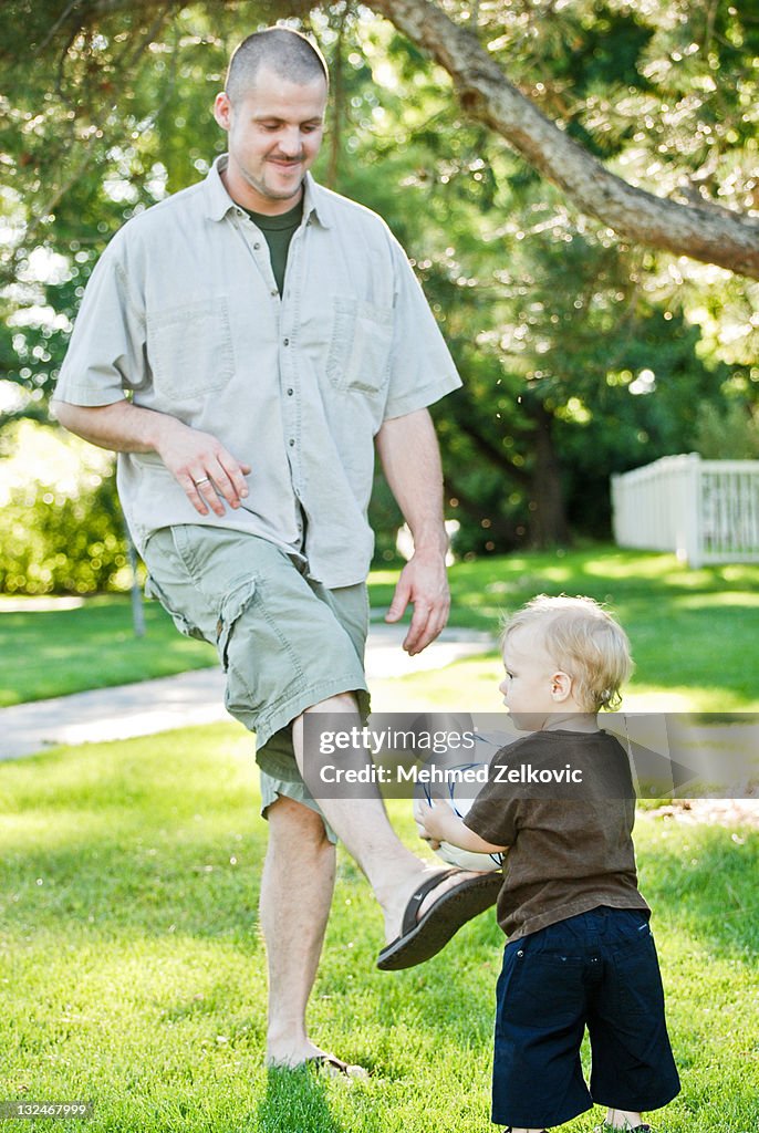 Father and Son Playing Soccer