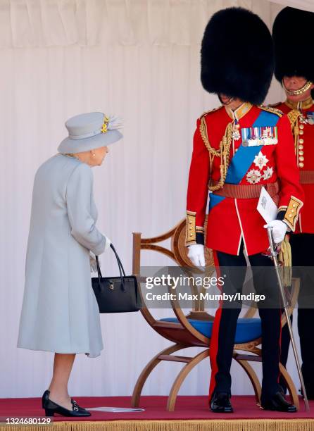 Queen Elizabeth II accompanied by Prince Edward, Duke of Kent attends a military parade, held by the Household Division in the Quadrangle of Windsor...
