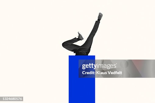 Young man upside down in blue rectangle Young man upside down in blue rectangle