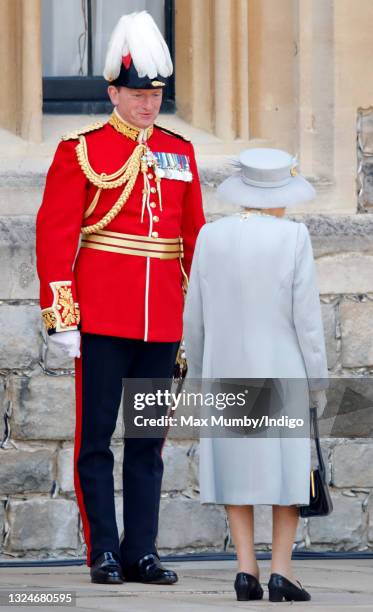 Queen Elizabeth II talks with Major General Chris Ghika during a military parade, held by the Household Division in the Quadrangle of Windsor Castle,...
