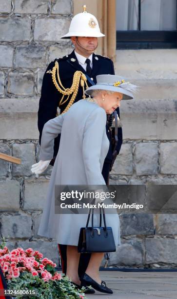 Queen Elizabeth II attends a military parade, held by the Household Division in the Quadrangle of Windsor Castle, to mark her Official Birthday on...