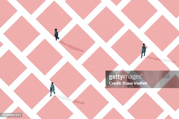 man and women walking in pink maze - shape color identity series bildbanksfoton och bilder