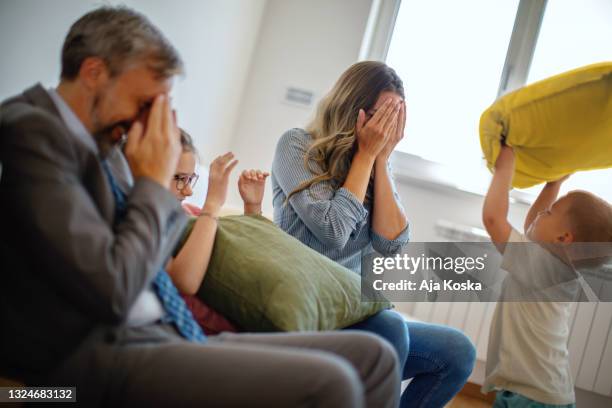 family moving into a new apartment. - mom head in hands stock pictures, royalty-free photos & images