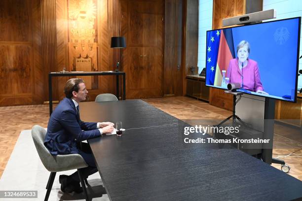 Austrian Chancellor Sebastian Kurz talks to German Chancellor Angela Merkel in a video conference during the coronavirus pandemic on June 21, 2021 in...