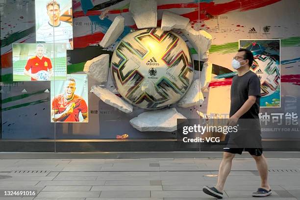 Adidas Uniforia match ball is displayed in the window of an Adidas flagship store on June 20, 2021 in Beijing, China. Adidas Uniforia is the official...