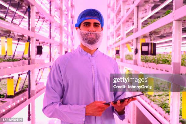indoor portrait of young farm technician with digital tablet - hair net stock pictures, royalty-free photos & images