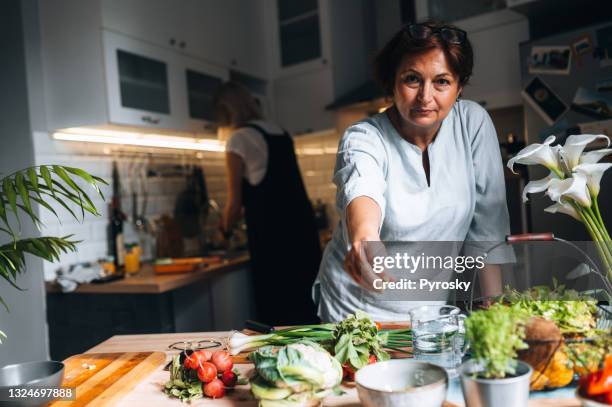 close-up of a woman spicing up the dish - sprinkling salt stock pictures, royalty-free photos & images